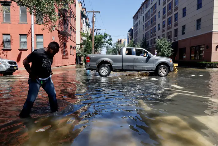 A man walks through a flooded street in Hoboken, New Jersey on Sept. 2, 2021, the morning after the remnants of Hurricane Ida drenched the area.